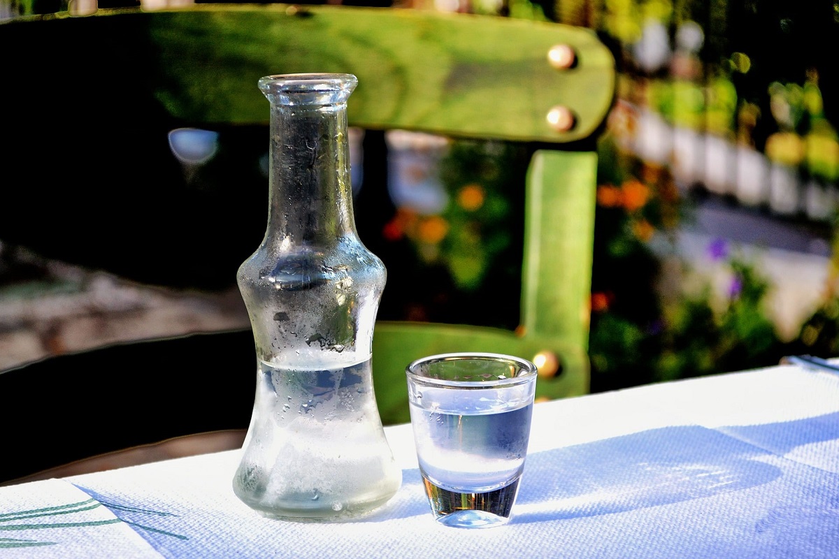 sticluta de tarie cu un pahar de shot langa, pe o masa alva, la Zexe Herastrau - bauturi românești tradiționale