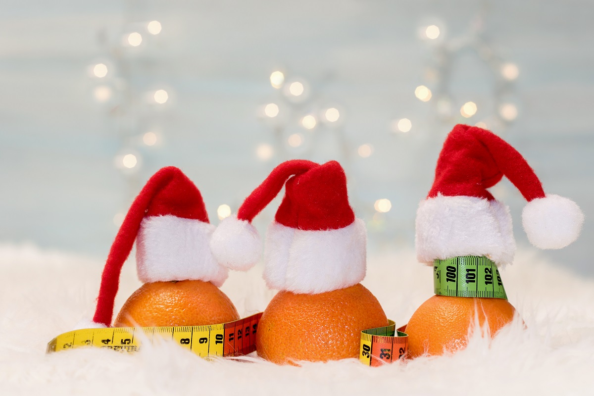 Christmas background with tangerines and measuring meter. Concept of the Christmas diet