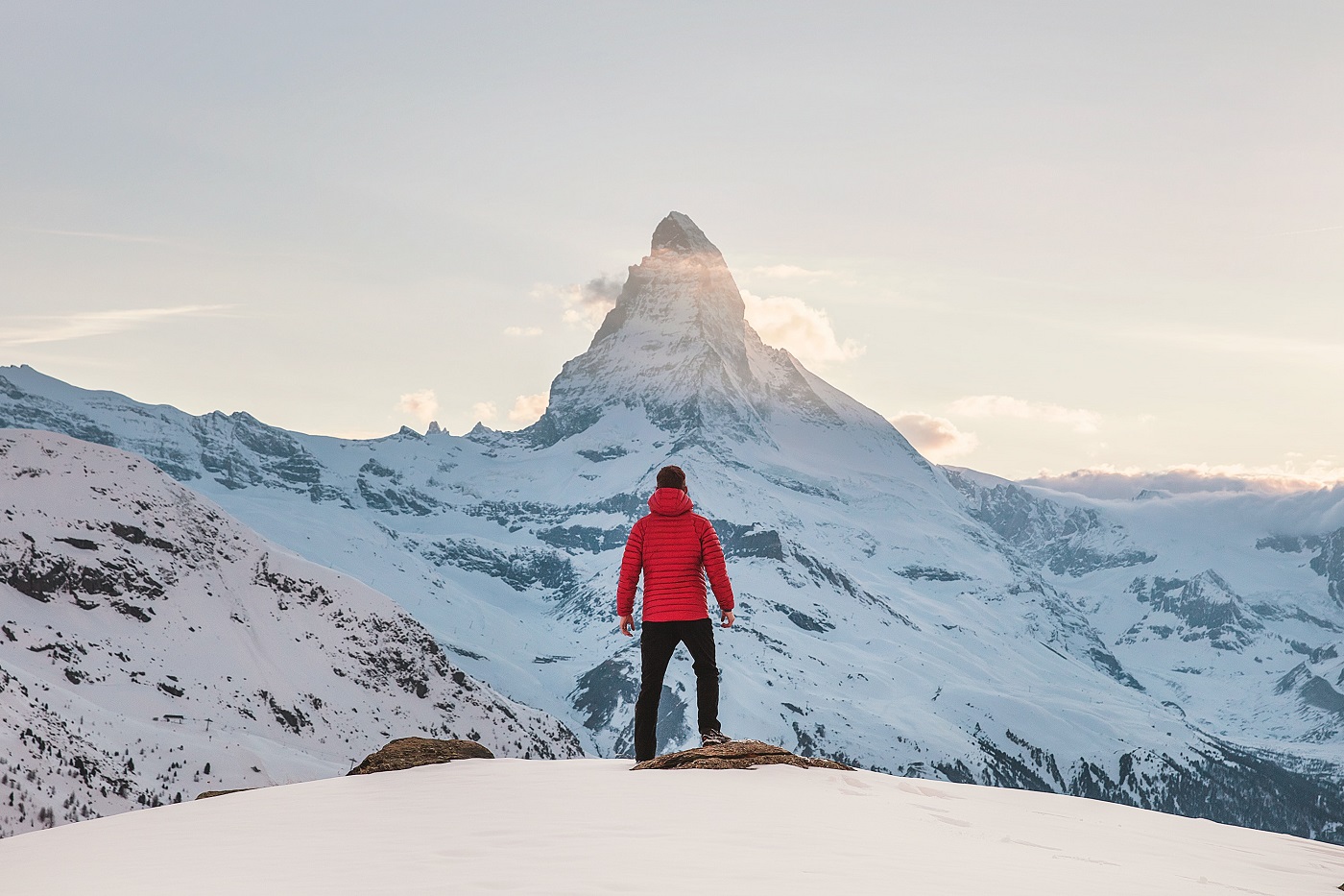 barbat fotografiat din spate care admira vârful Matterhorn din Elveția, la apus